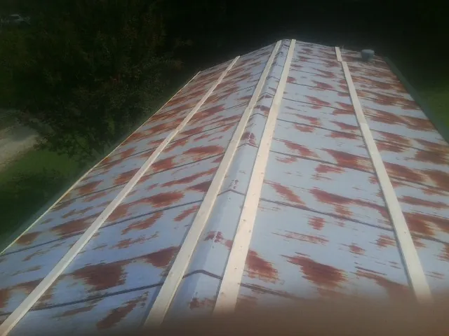 Rusted metal roof panels with new wood purlins before replacement — Storm Damage Roof Repair in Trinity Center by Roofing Brothers