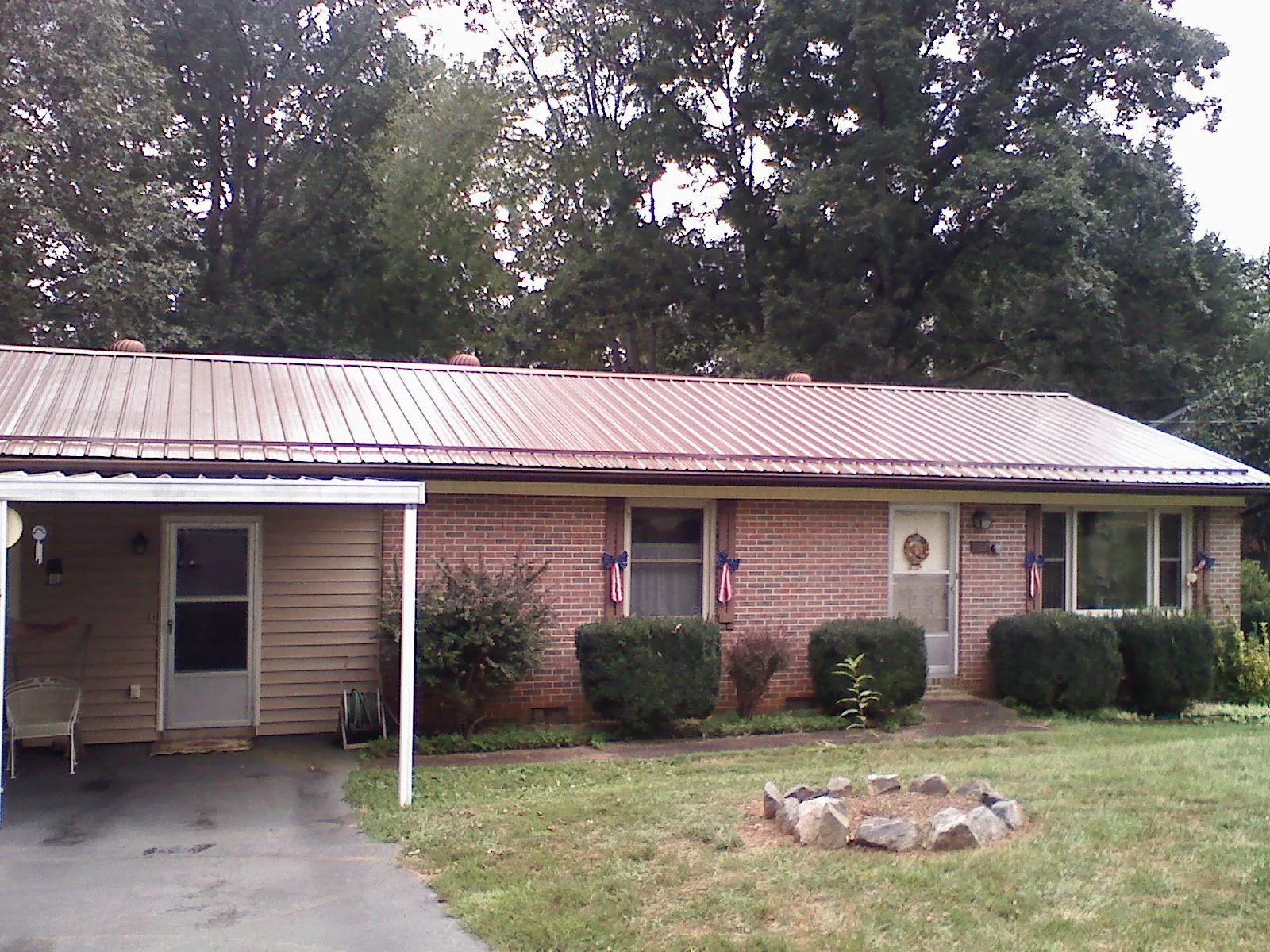 Bronze metal roof and carport on a brick ranch home — Roof Repair work by our crew in Trinity Center